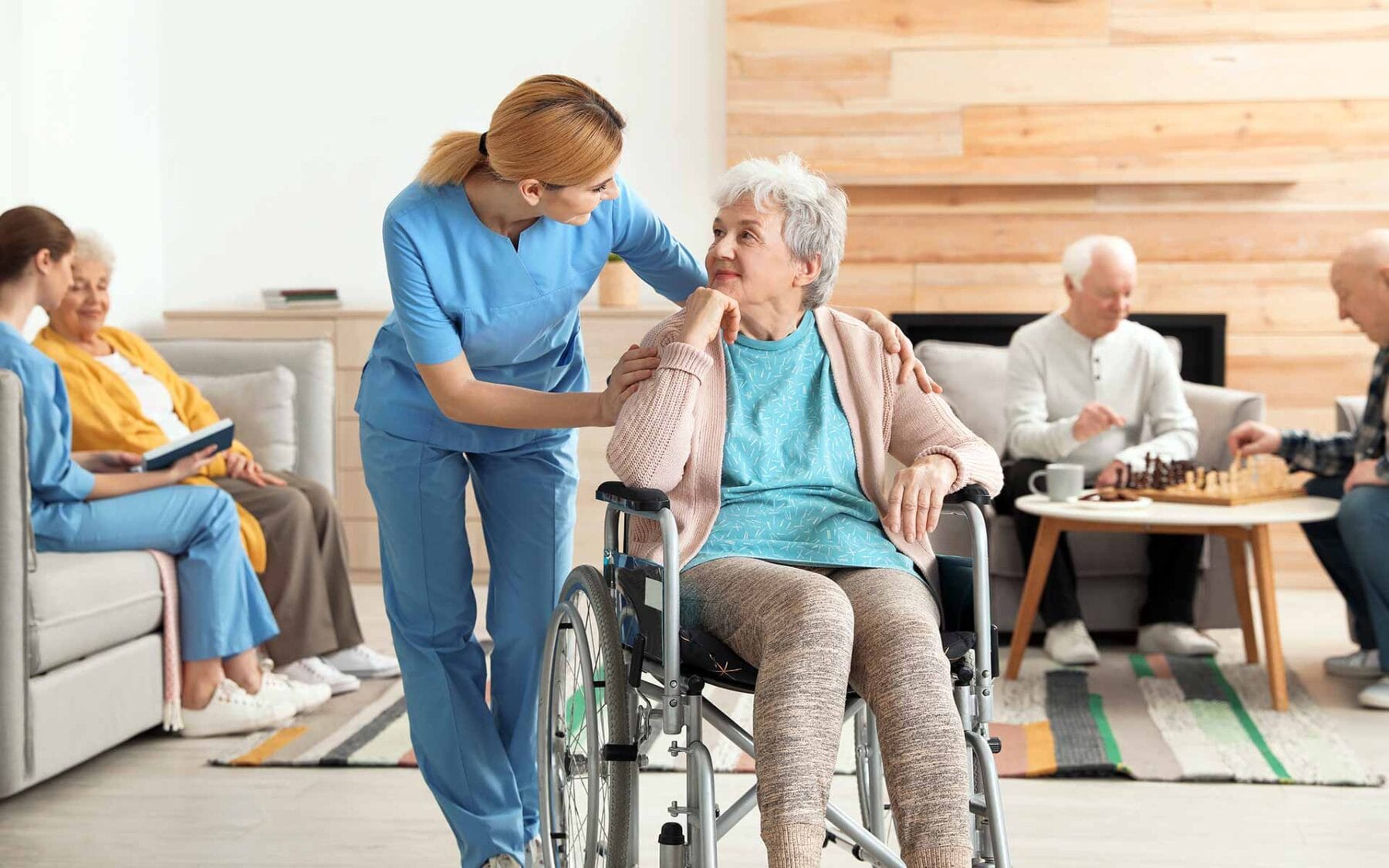 Older lady in wheelchair being cared for in aged care home