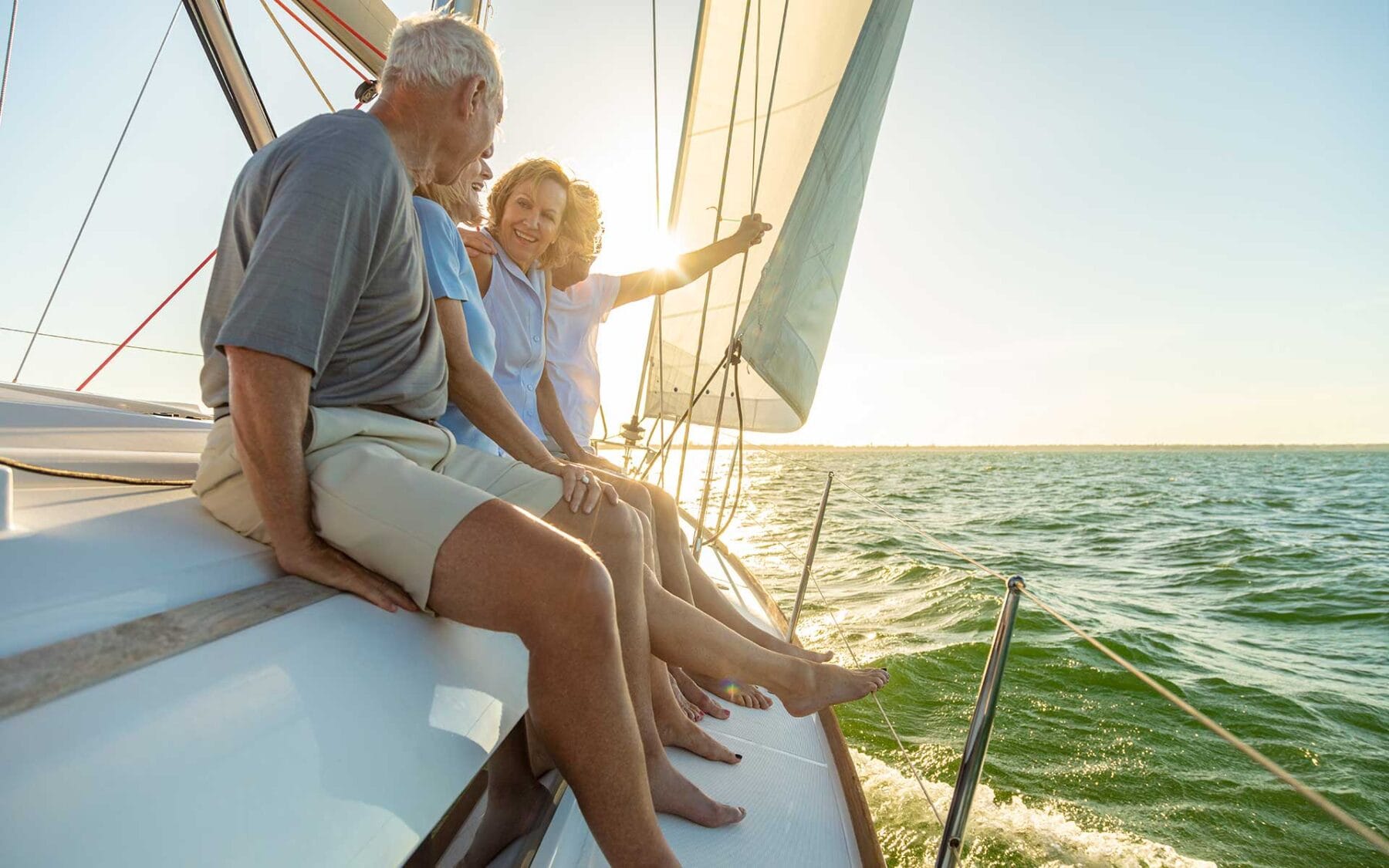 Older people sitting on yacht sailing in sea